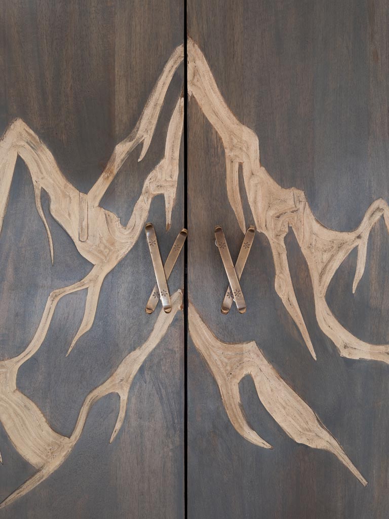Close up of Wooden Cabinet panels engraved with a mountain 
