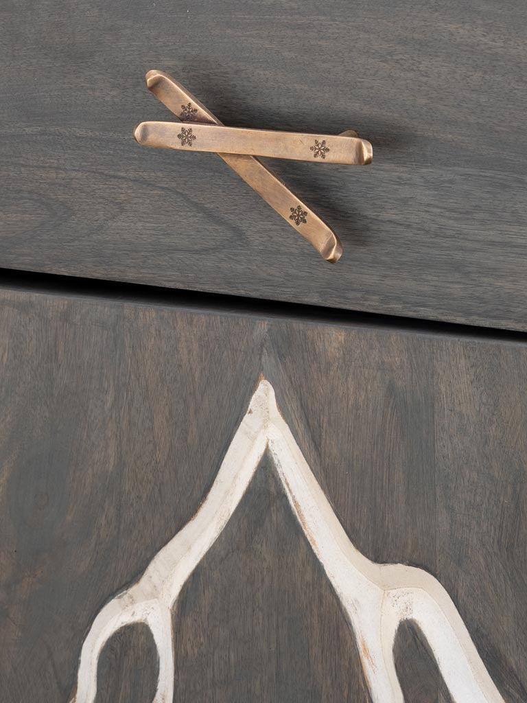 Close up view of Bedside table engraved with a mountain & ski handle